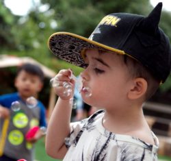 blowing bubbles to celebrate canada-wide early learning & child care plan