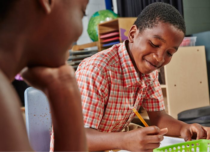 Child writing at a desk